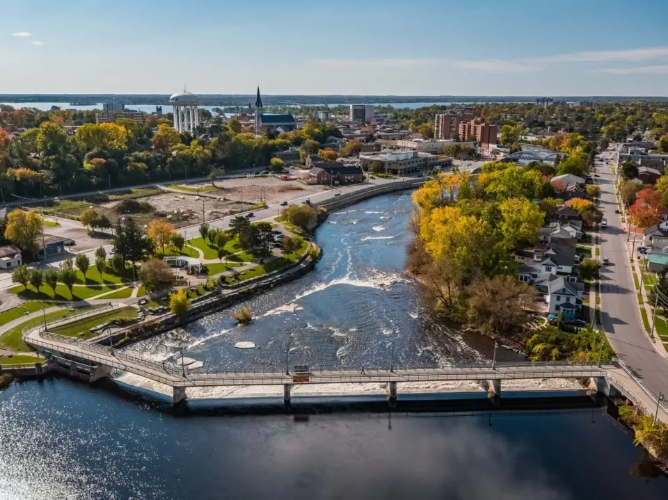 Aerial view of Russell Ontario showing the river, bridge, mature trees and small-town neighbourhood